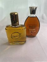 Two vintage men's colognes, Stetson and Bronze Beauter bottles photographed together on white background.