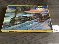 Box with vintage winter railway illustration showing train steaming across snow-covered landscape.