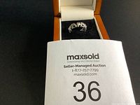 Photo of lot number card with the ring placed inside a jewelry box