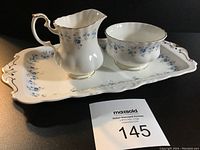 View of the cream and sugar set with tray showing floral pattern and gold trim