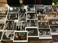 Overview photo showing a large collection of approximately 25 black and white vintage 8x10 photographs of Johnny Carson, Ed McMahon, and other figures in talk show and candid moments.
