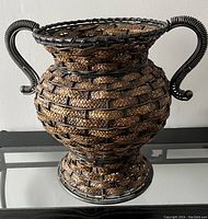 Full view of large woven planter with metal frame and two handles