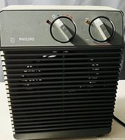 Front view of a Philips heater showing two control knobs and front grille.