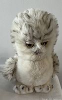 Front view of the snowy owl plush showing the detailed face, wings and soft fur texture.