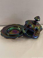 Side view of the Carnival Glass butter server with lid removed showing the iridescent finish and scalloped edge base.