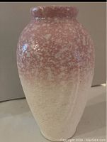 Full view of the vase showing the pink and white textured glaze transitioning from pink top to white bottom.