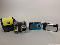 Overview of three cameras and Ryobi carrying case
