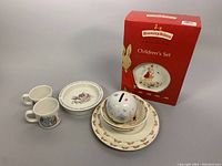 Royal Doulton Bunnykins 3-piece children's dish set with original red box, including coin bank, bowl, two mugs, and plates.