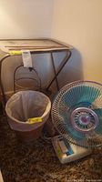 View of all items in the lot including snack table, plate stand, wastebasket, and Tatung table fan on floor.