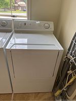 Full front view of the Maytag white clothes dryer showing the closed door and control panel.