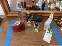 Wide view showing multiple perfume bottles including Yves Saint Laurent Opium and Boss Bottled