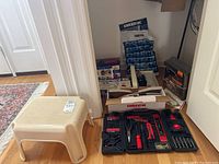 Full view of tools and boxed vacuums with plastic step stool