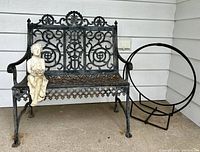 Bench, statuette and log holder arranged together on porch floor