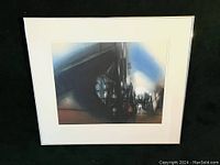 Frontal photo of the framed watercolor painting "Rail Bridges" by Donald Stoltenberg showing the dark industrial bridge structures with blue and white atmospheric background.