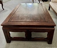 Top-down view of the rectangular teak coffee table showing beveled edges and wood grain.