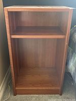 Front and right-side view of the wooden bedside shelf showing adjustable middle shelf.