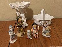 Overview of all figurines and ceramic pieces on wooden surface