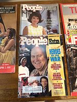 Photo showing three magazines: People tribute to Jacqueline Kennedy Onassis, People Weekly Extra with Norman Schwarzkopf cover, and partial view of a 1956 magazine with Arctic Beachhead