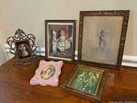 Overview of five small antique framed portraits on a table, showing each piece, frames in metal and wood with ornamental details.
