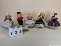 Full view of five Madame Alexander 7-inch dolls lined up side by side