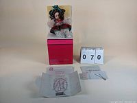 Marie Osmond doll on box with paperwork and number placard