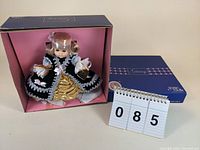 Front view of Vogue Ginny doll in original box, showing dress and accessory