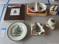 Photo showing the full set of Spode Christmas Tree tableware items arranged on a table including plates, divided dishes, trinket dishes, and salt and pepper shakers.