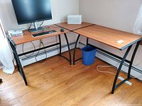 Full view of the 3-piece desk ensemble showing corner piece, two rectangular desks with metal frames and laminate wood finish tops.