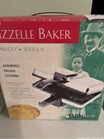 Box packaging for VillaWare Prego Series II Pizzelle Baker showing product image and features.