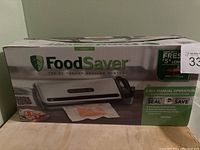 Original boxed FoodSaver vacuum sealing system showing packaging design.