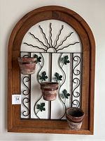 Wooden arched wall planter with metal vine and leaf design. Three terracotta pots attached, showing wear.