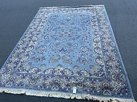 Full view of rug laid flat showing entire pattern and fringe