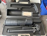 Bushnell spotting scope with tripod and carrying case inside molded plastic case