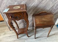 Two vintage wooden side tables shown together on floor, displaying size and appearance.