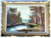 Full view of framed landscape painting showing ornate gold-finish wood frame and visible signature