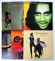 Six vinyl record jackets laid out showing front covers for identification, including Fleetwood Mac Rumours and Alice Cooper Goes to Hell.