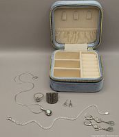 All jewellery pieces displayed with open zippered velvet storage box