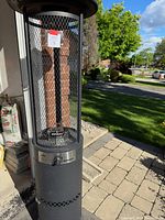 Full view of the Inferno outdoor heater showing the mesh cage and missing glass tube inside the upper section.