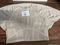 Full front view of the cream knit Ronny Mobo dress showing texture and sleeve shape