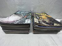 Two stacks of comic books placed side by side showing thickness and quantity of lot