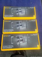 Three boxed Blackweb Full Motion TV Wall Mounts stacked, showing front of boxes with product name, TV size range 50in to 86in.