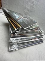 Stack of 40 Tomb Raider comic books, side view showing thickness and quantity