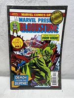 Front cover of Marvel Presents #1 Bloodstone comic showing colorful artwork of Bloodstone fighting a green monster with cityscape background.