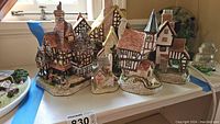 Group shot of five David Winter cottages on a table