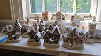 Front and center view of all eleven houses displayed on table