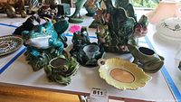 Overview of the ceramic frog figurines, tape dispenser, plant pot, and candle holder spread on flat surface