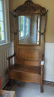 Full front view of oak hall tree bench showing mirror, seat and hooks