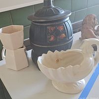 Photo showing the McCoy pottery set including creamer, cookie jar, and smaller white pottery pieces.