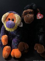 Both toys Congo and Bananas sitting side by side showing their front side and tags