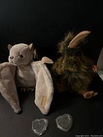 Photo of the two Ty Beanie Buddies plush bats named Beak and Batty, showing front and back views of the plush toys with tags visible.